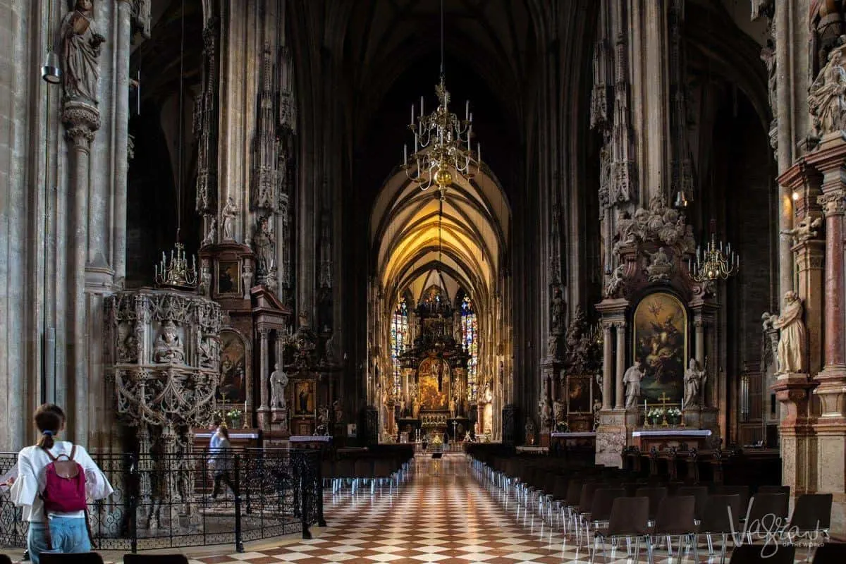 A tourist stands in the St Stephens Cathedral Vienna