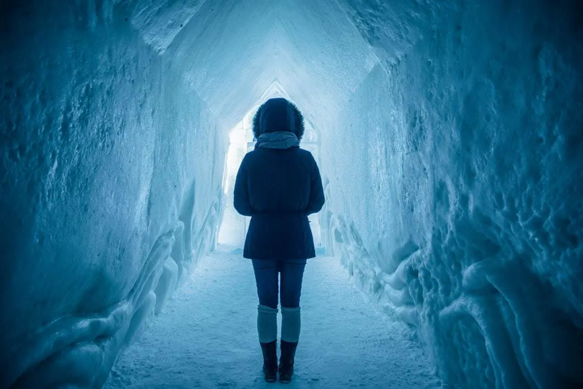 Girl standing in the Langjökull ice tunnel in Iceland in winter