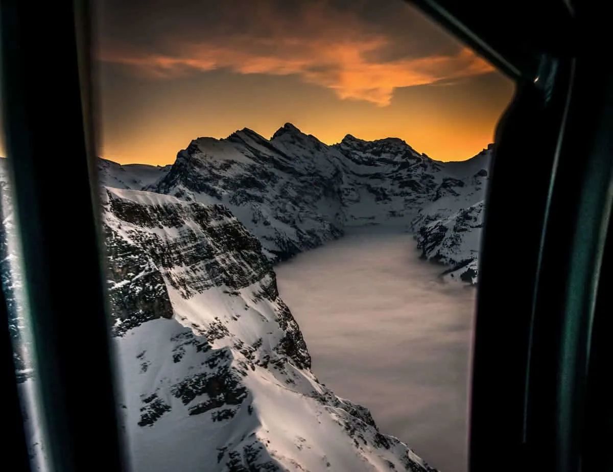 Taking a helicopter flight over the Swiss Alps in winter