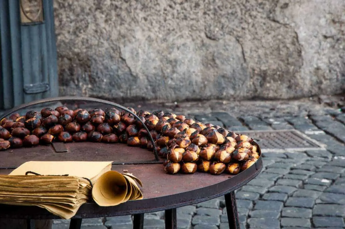 Roasted Chestnut stand with paper cones - One of the things to do in Europe in winter is experience the chestnut festival in Portugal