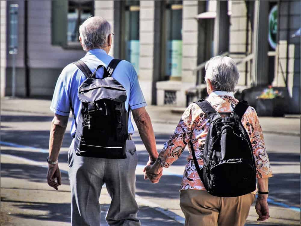 Best anti-theft backpack for travel. Two elderly people wearing backpacks. Is travel safe it is when you have anti theft travel gear