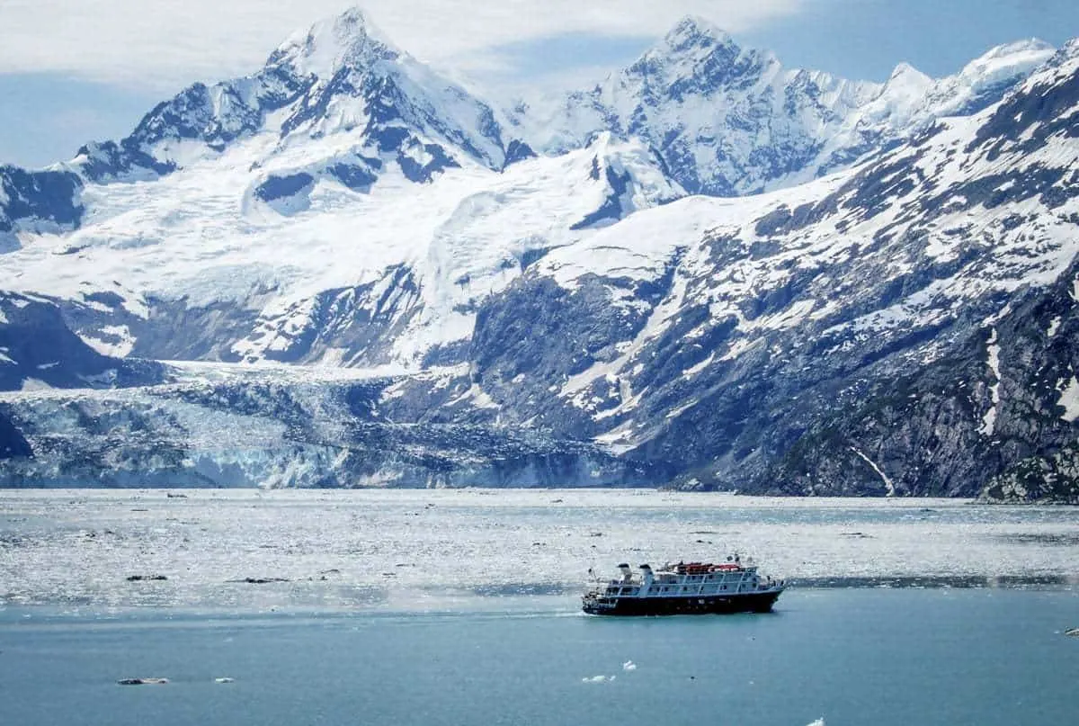 Alaskan winter cruise ship looking small against the ice and mountains. 