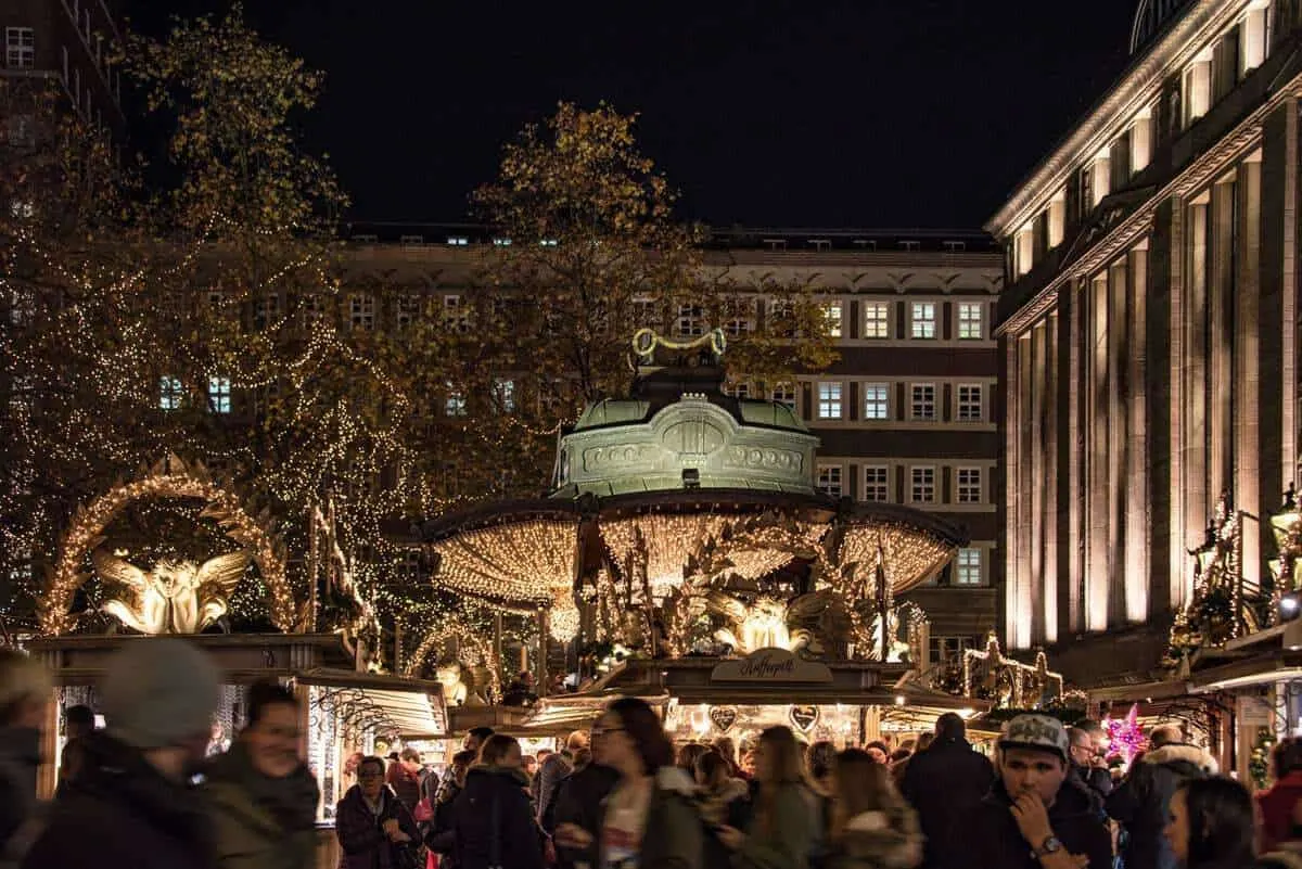 Dusseldorf Christmas market crowd and merry go round.