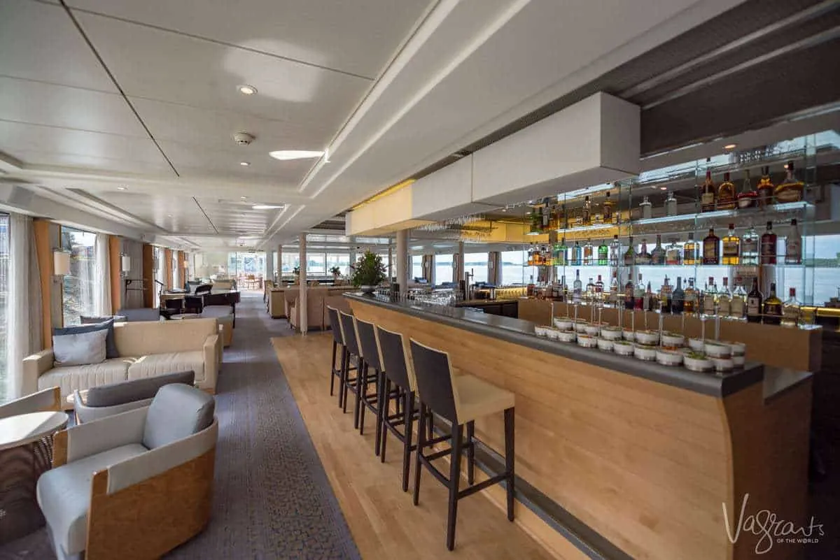 The bar on a viking river cruise. The bar is lines with fancy glasses and high end booze. How should you dress for a viking cruise. Smart casual is the answer, remember you are on holiday and want to look good and be comfortable.