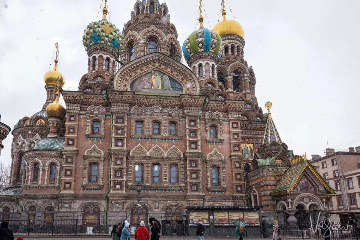 Colourful cathedral in St Petersburg with light snow falling. You may ask what should I pack for a european river cruise. The cruise packing tip here is to always be prepared for changes in the weather. You never know when it may snow.