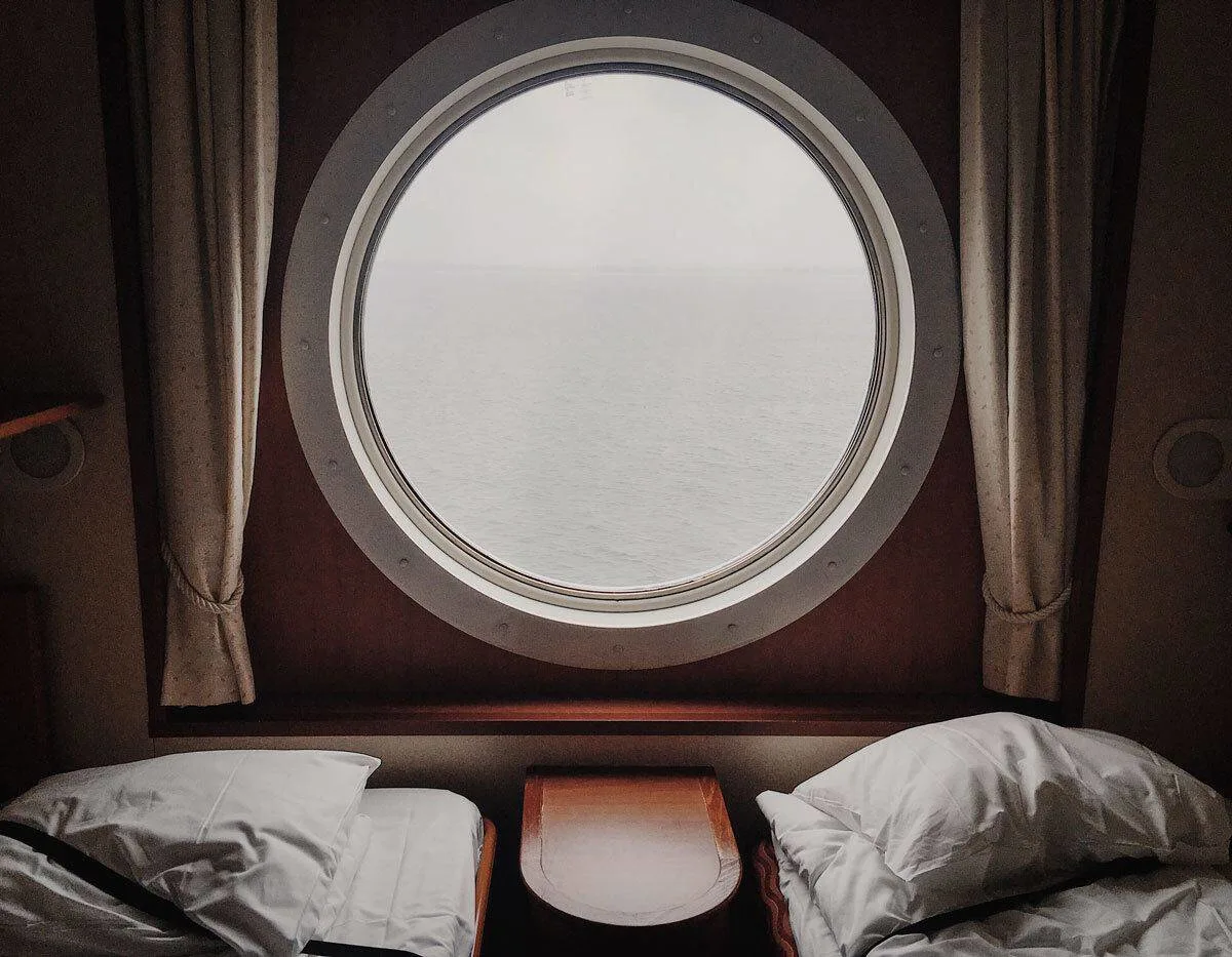 View of porthole in a ship cabin. Remember cabin safety to stay safe on a cruise. Keep your door locked at all times. 