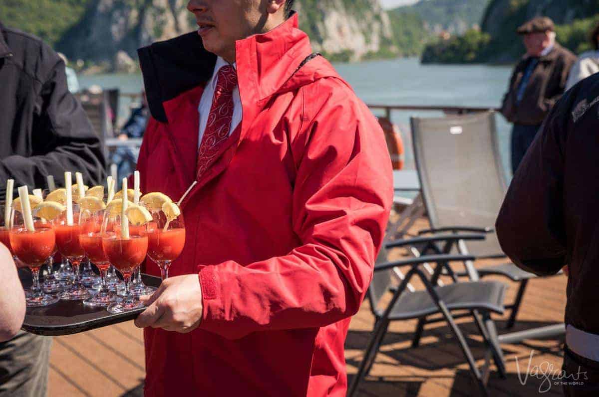 Man serving cocktails on a ship - Always be careful how you drink on a cruise to stay safe. 