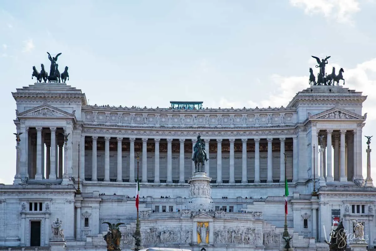 The Vittorio Emanuele II Monument with a man on horse statue at the front and chariots either side. 
