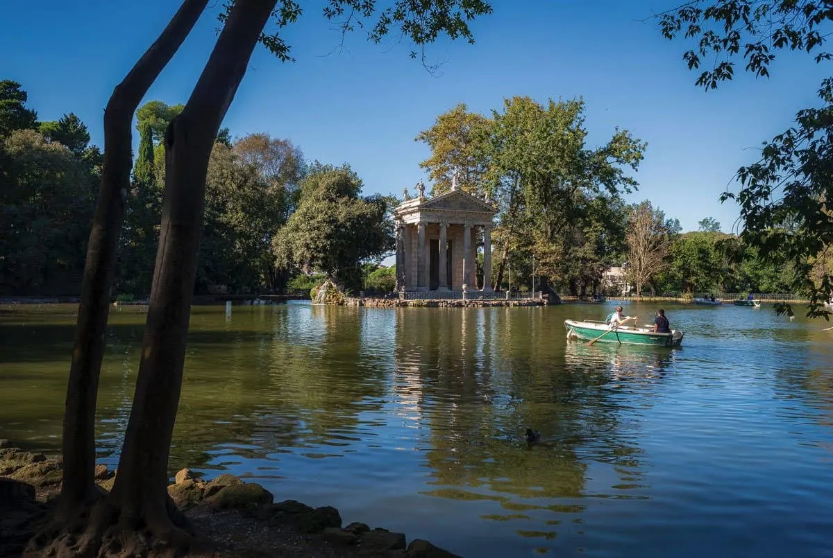 People rowing a boat to Villa Borghese.