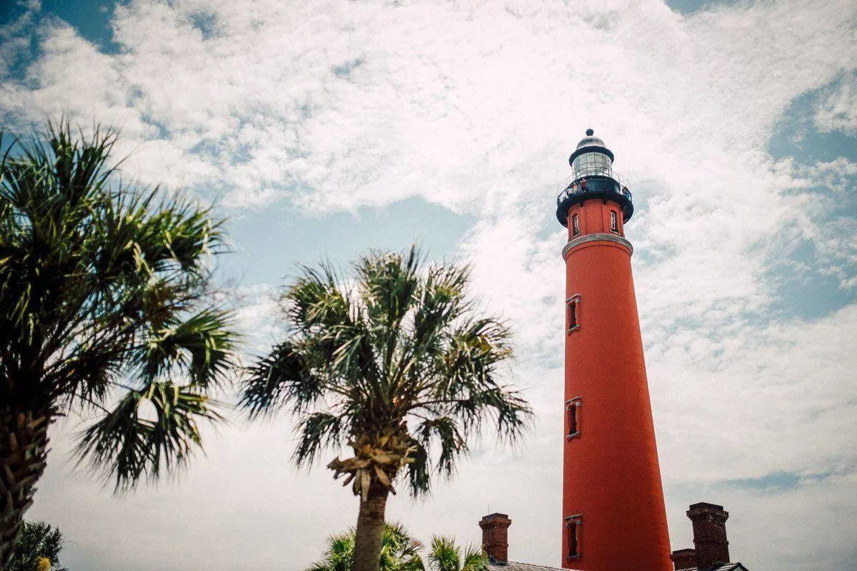 Red lighthouse and palm trees in Key West. 