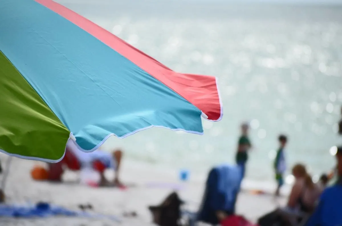 Beach umbrella with out of focus beach in summer in Florida. 