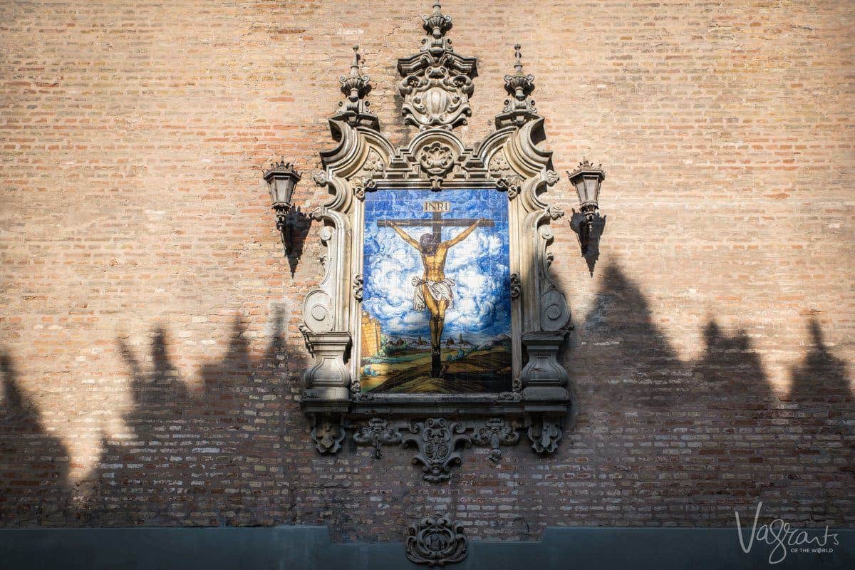 Mosiac of Jesus on the Cross on a wall in Seville. 