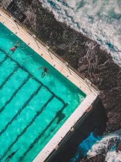 Best Travel Exercise Equipment - Aerial shot of people doing laps in a pool