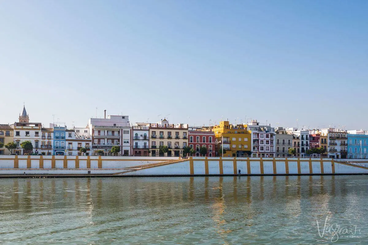 Colourful houses as a backdrop to the river in Triana Seville. 