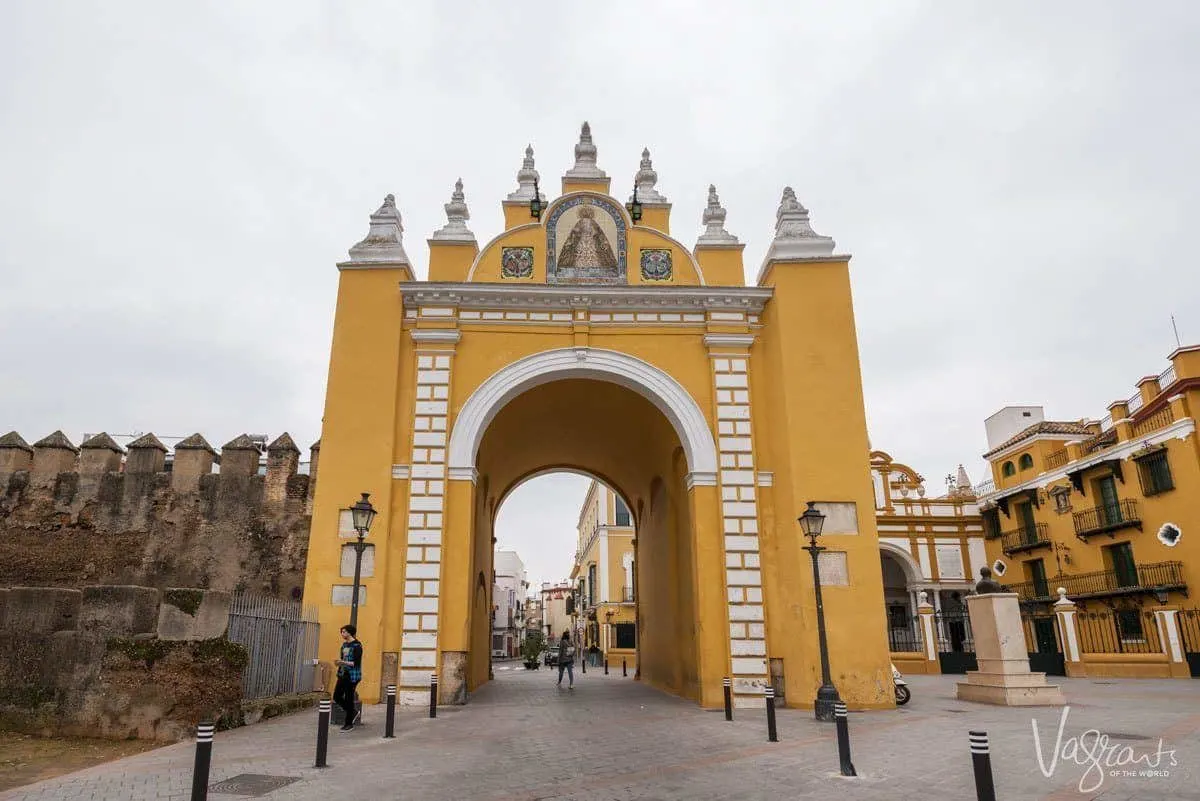 Gold and white arched Macarena Gate Seville.