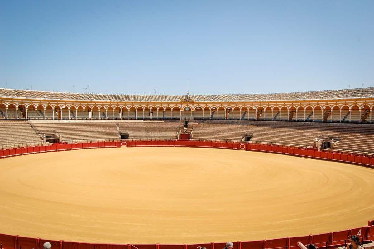 Circular sand bullring and seating at Seville bullring. 