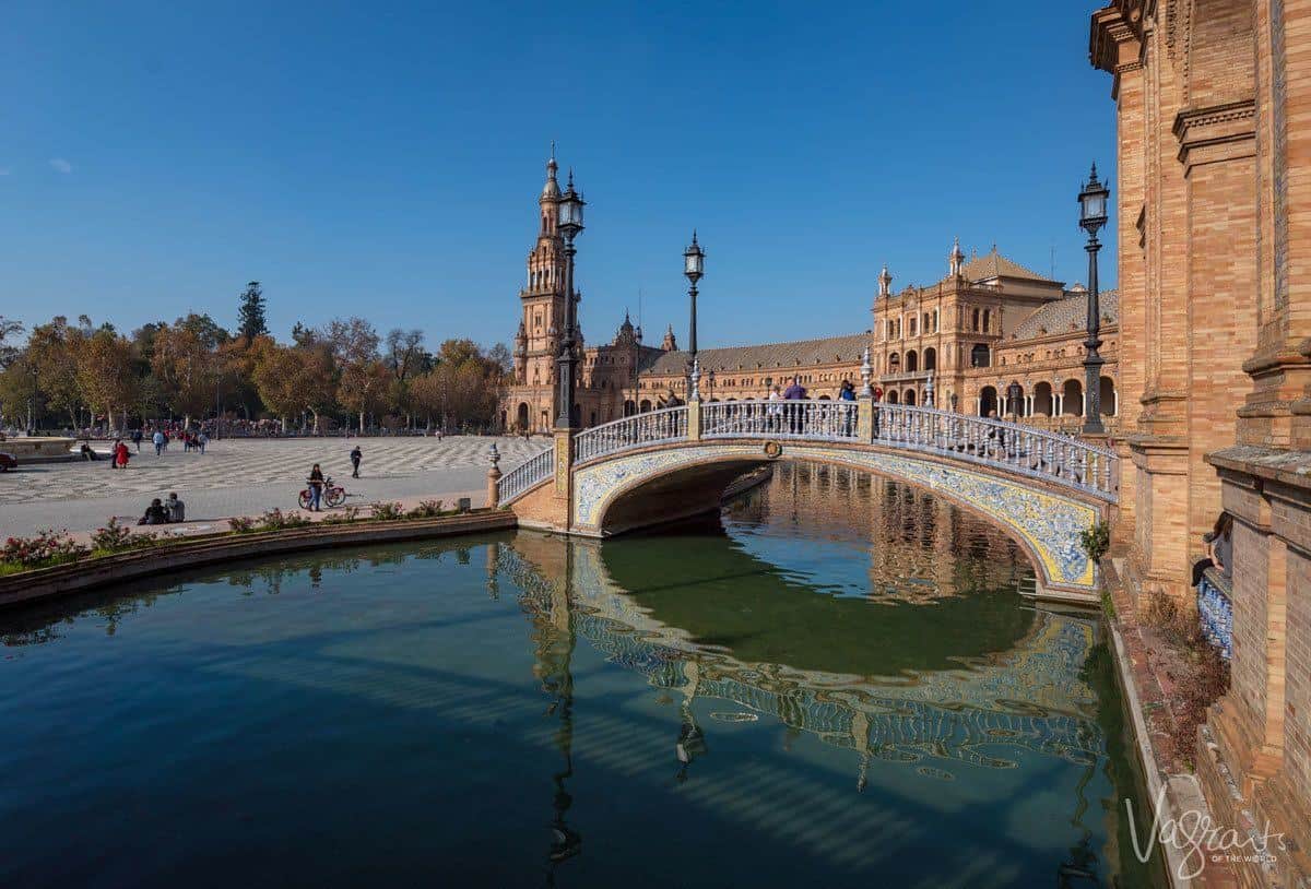 Tiled walking bridge over a moat around Plaza de España Seville. 