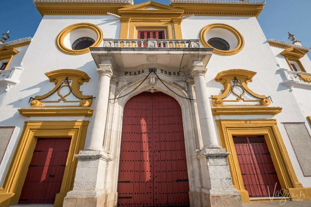 Grand red, white and gold entrance to Plaza de toros de la Real Maestranza de Caballería de Sevilla, the home of bullfighting in Spain.
