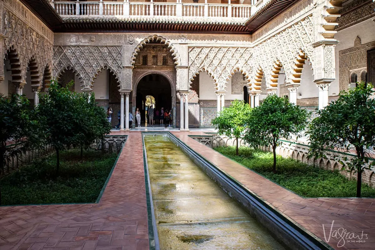 The indoor pond and gardens at the Royal Alcazar Palace is one of the best things to do in Seville for it's beautiful architecture.