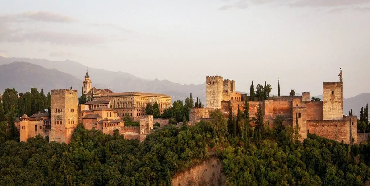 Sunset from afar over Granada. Add this to your Seville itinerary as the best Day Trips from Seville to Granada