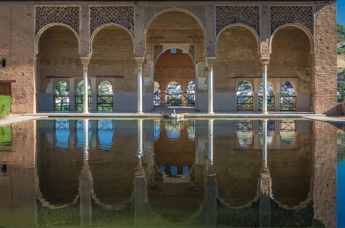 Arches reflected in pond in Granada, visiting here is one of the best free thing to do in Grananda. It is worth taking Day Trips from Seville to Granada