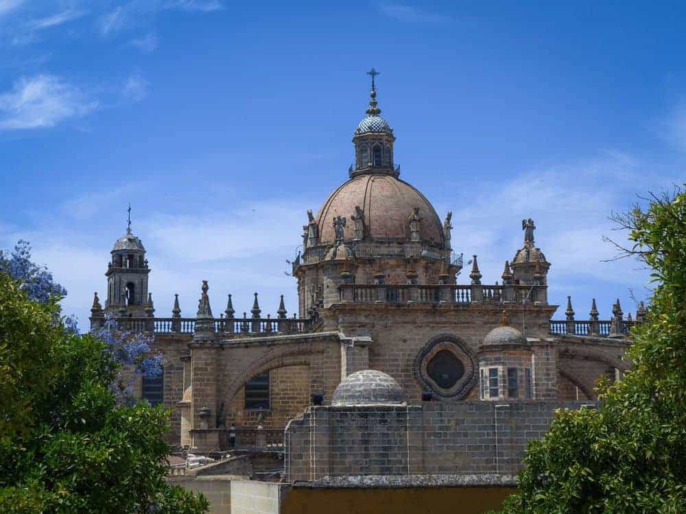 Jerez church with small statues around steeple. A must see on Day trips from Seville to Jerez