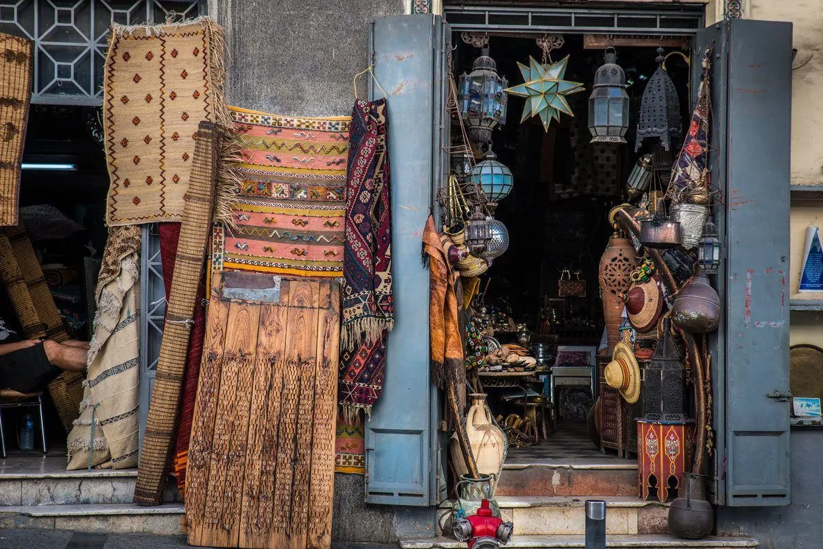 Carpets, pots and lanterns in street stall Tangier. This is one of the best Day trips from Seville. Go on the best day trips Seville to Tangier