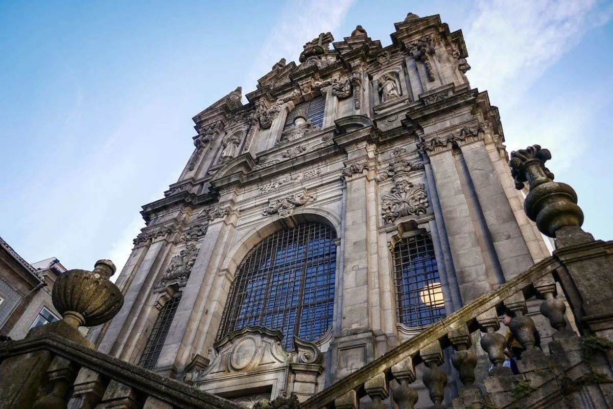 A skyward view of the stone and glass Torre dos Clerigos Church in Porto. 