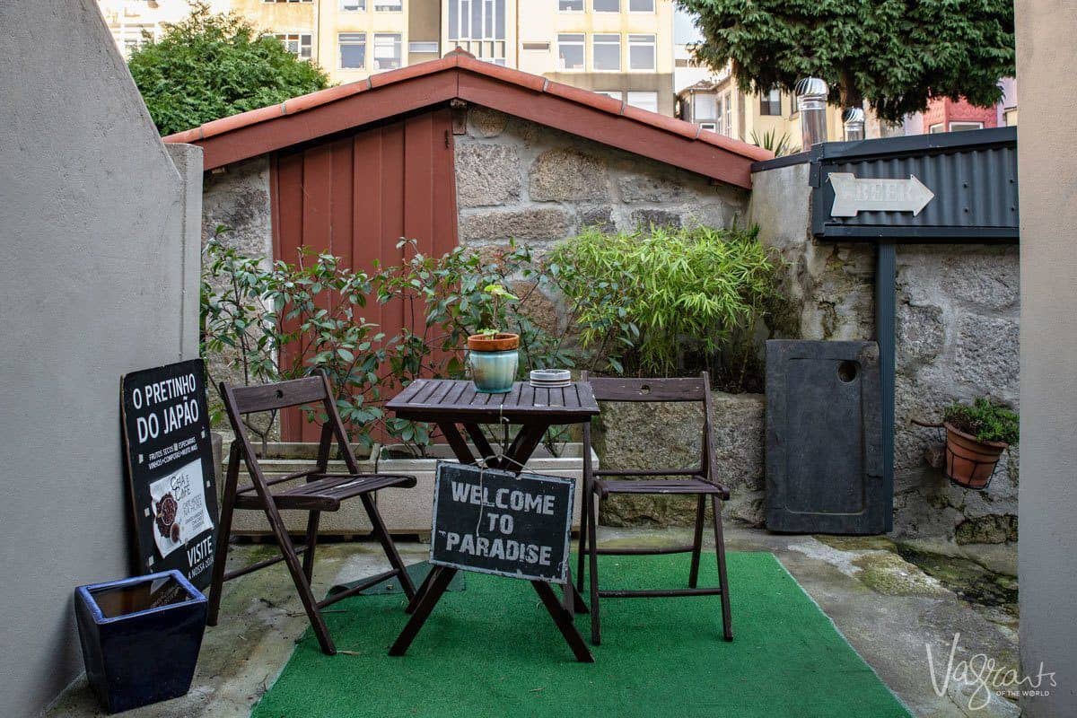 Welcome to Paradise sign in the hidden garden at Shop O Pretinho do Japao. 