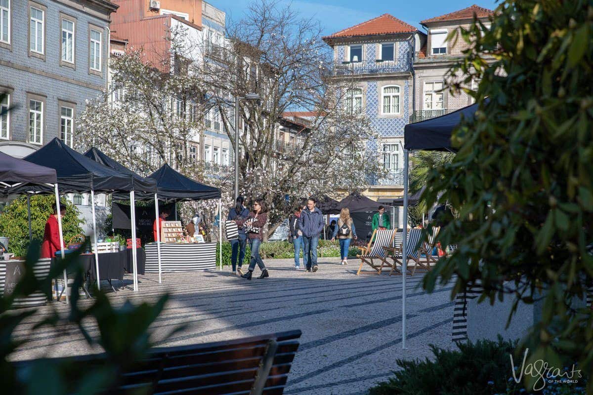 People walking through Porto Belo weekend market in the centre of Porto. 