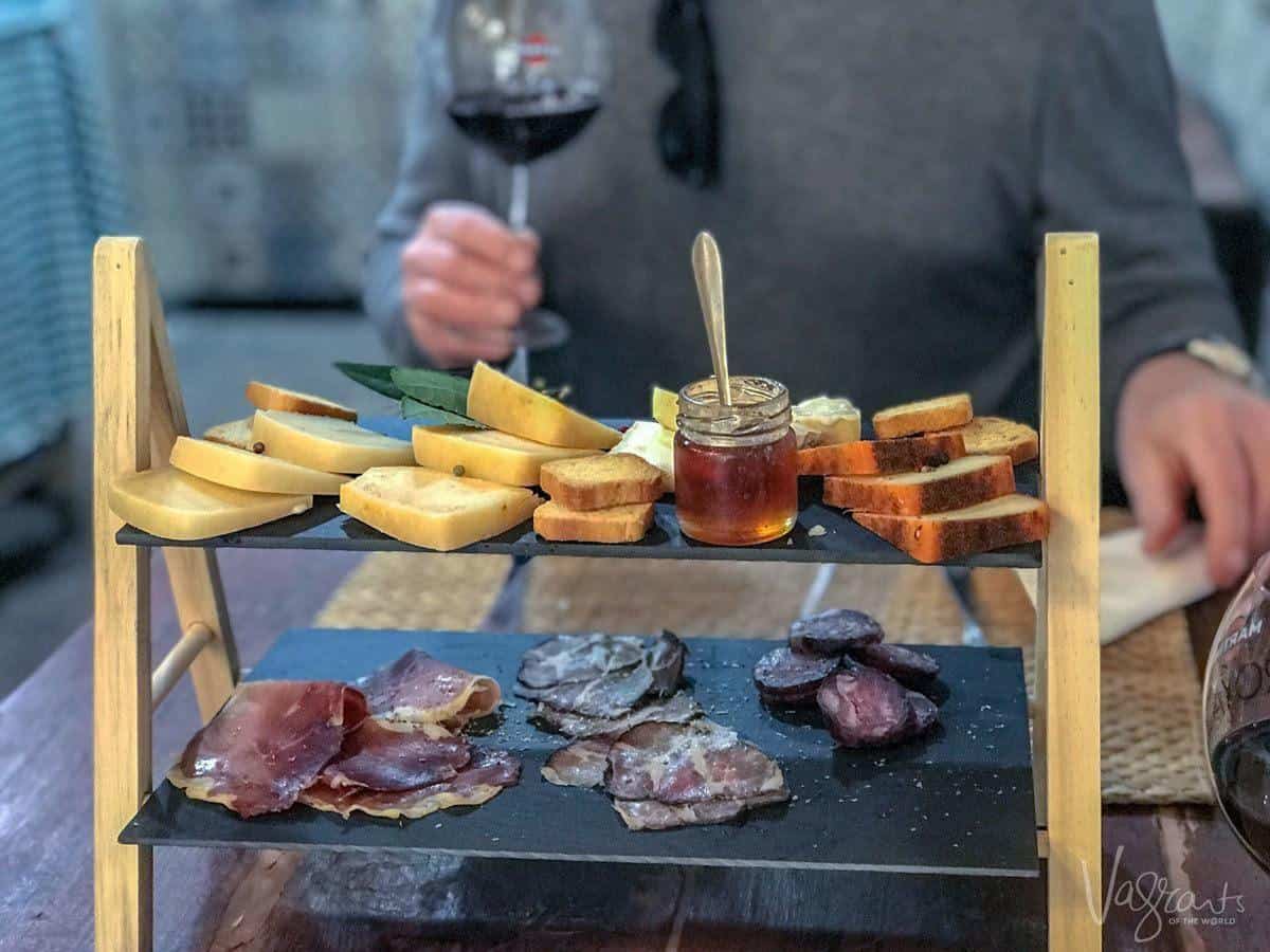 A two level cheese and meat platter at Queijaria Amaral Porto's oldest cheese shop. 