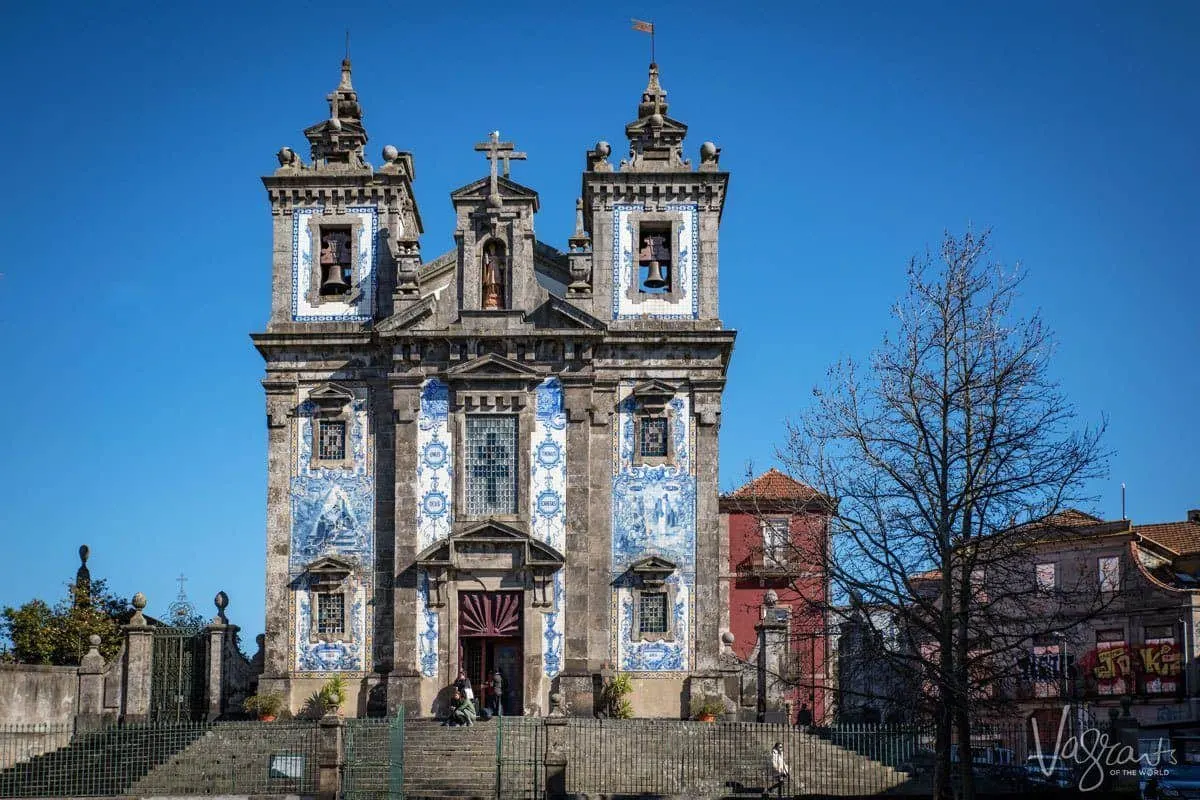 The stone towers and blue and white tiles of the ornate Church of Saint Ildefonso. 