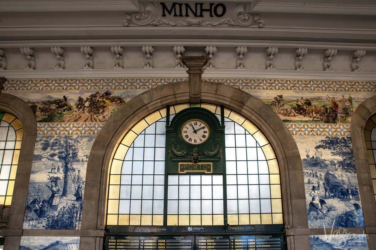 Clock and window surrounded by traditional azulejo tiles inside Sao Bento Train Station. 