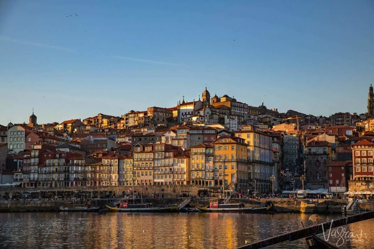 Multi coloured buildings on the hill in Porto Portugal as seen at sunset from across the Douro. 