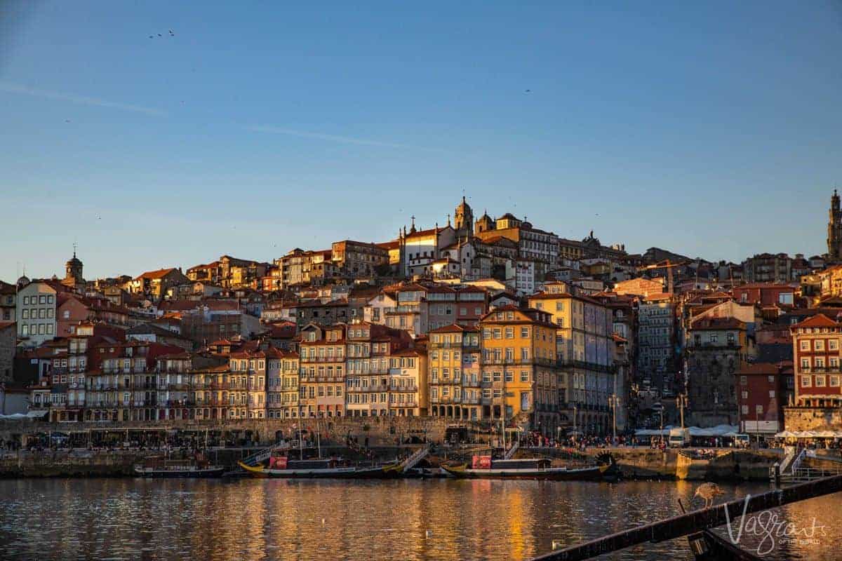 Multi coloured buildings on the hill in Porto Portugal as seen at sunset from across the Douro.
