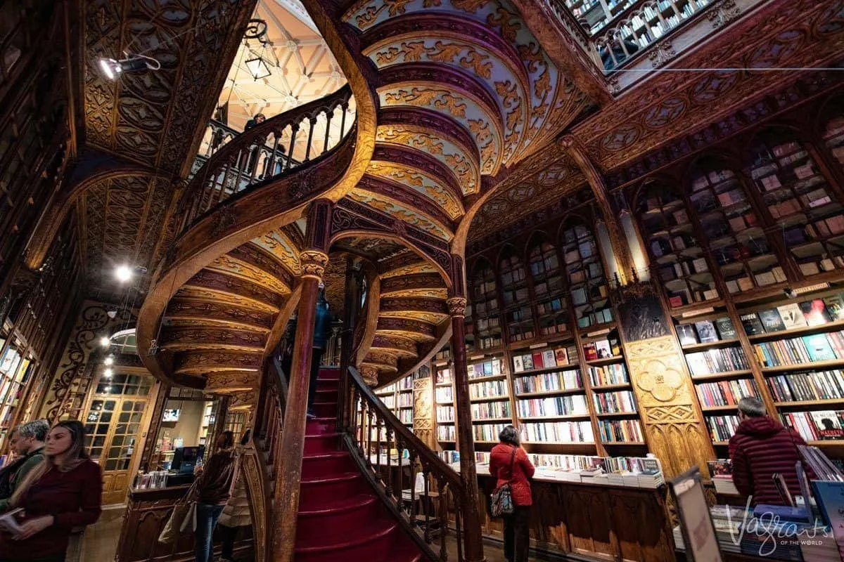 Gold wooden carvings under the spiral staircase at the Livraria Lello Bookshop. 