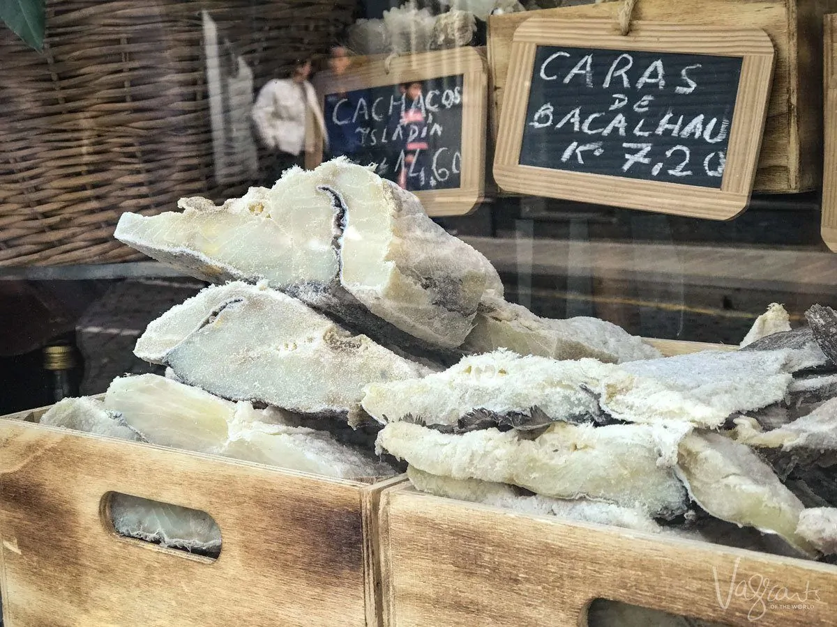 Typical Bacalhau dried cod fish in boxes in a shop window in Porto. 