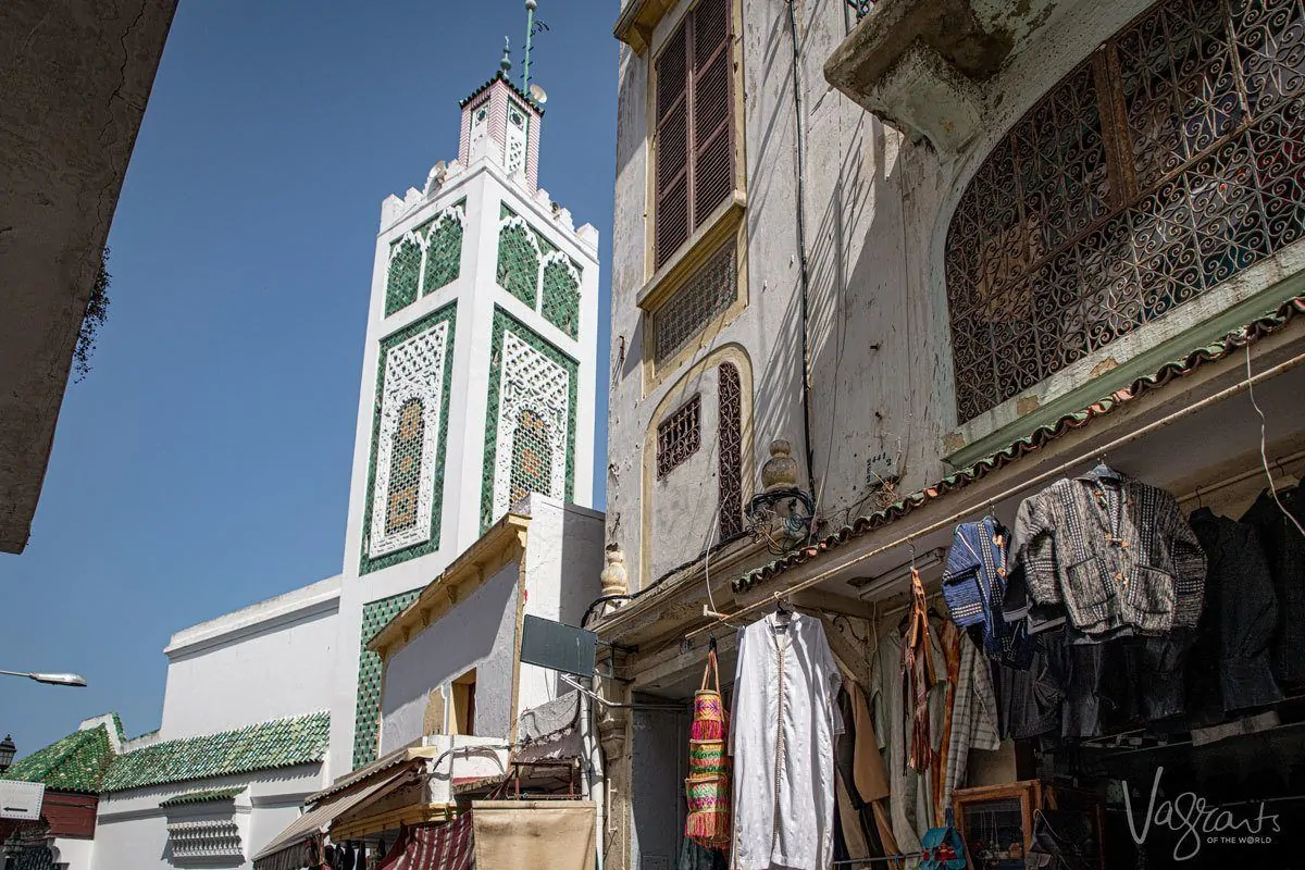 Green and white mosque at the end of a medina, Morocco