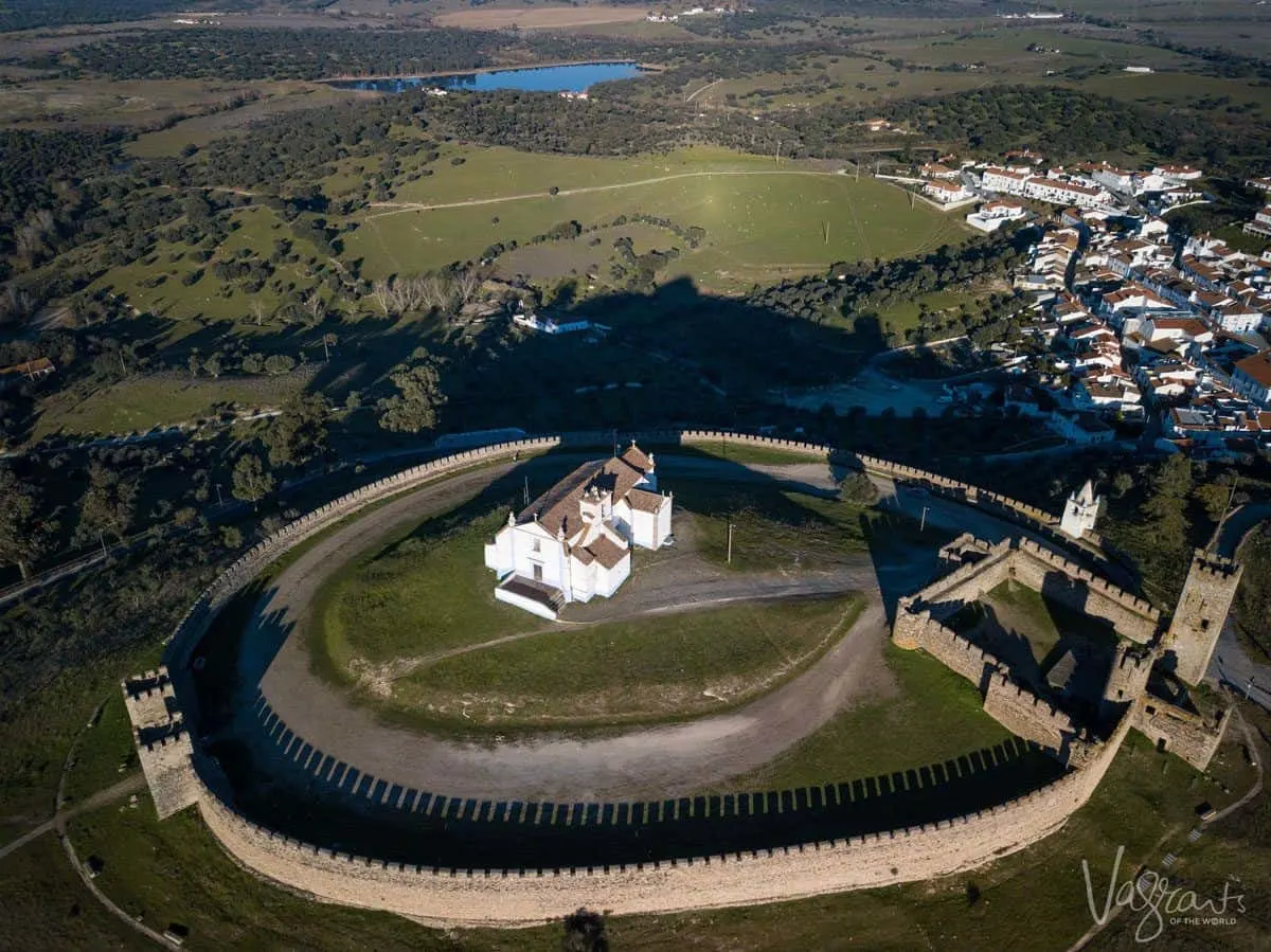 arial view of a circular castle with white church in the middle.  Looking for alentejo portugal highlights then this is certainly the place to stop on your alentejo road trip