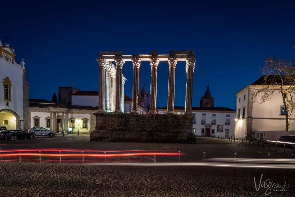 pillars of roman temple lit at night.
