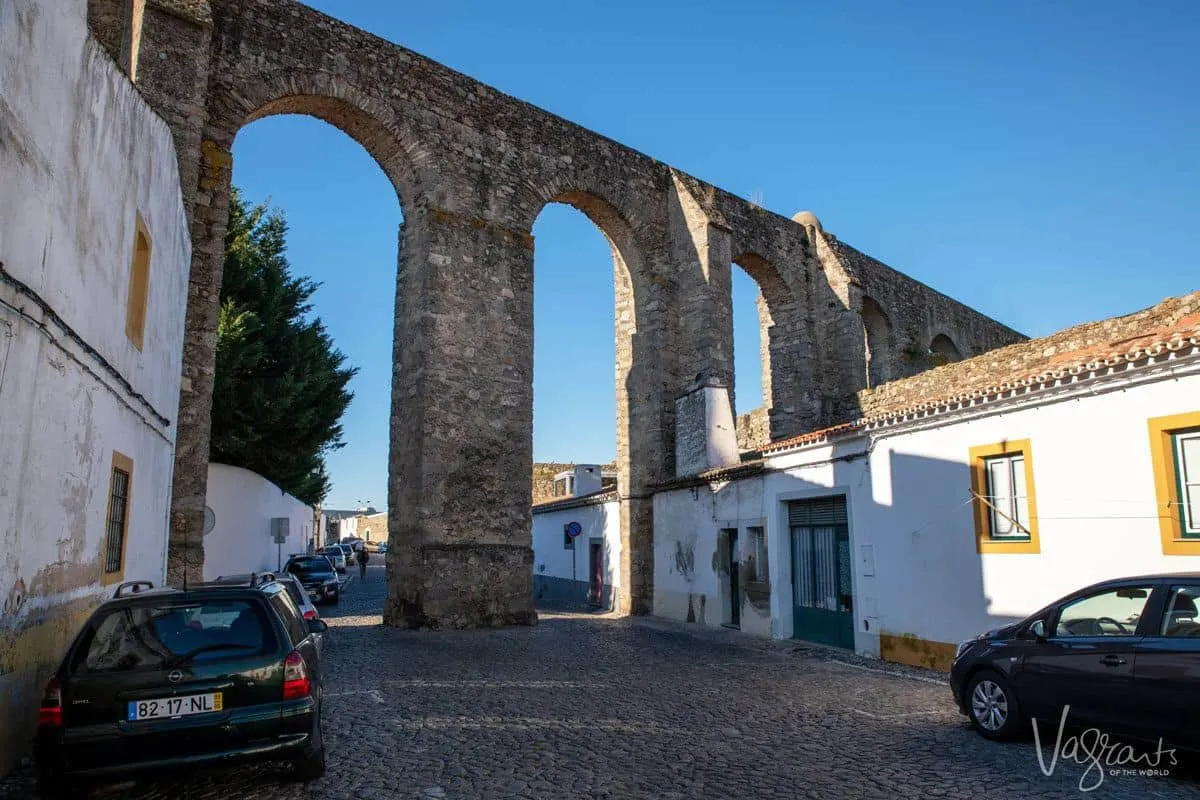 The aqueduct runs through the streets and over houses of Evora Portugal. 