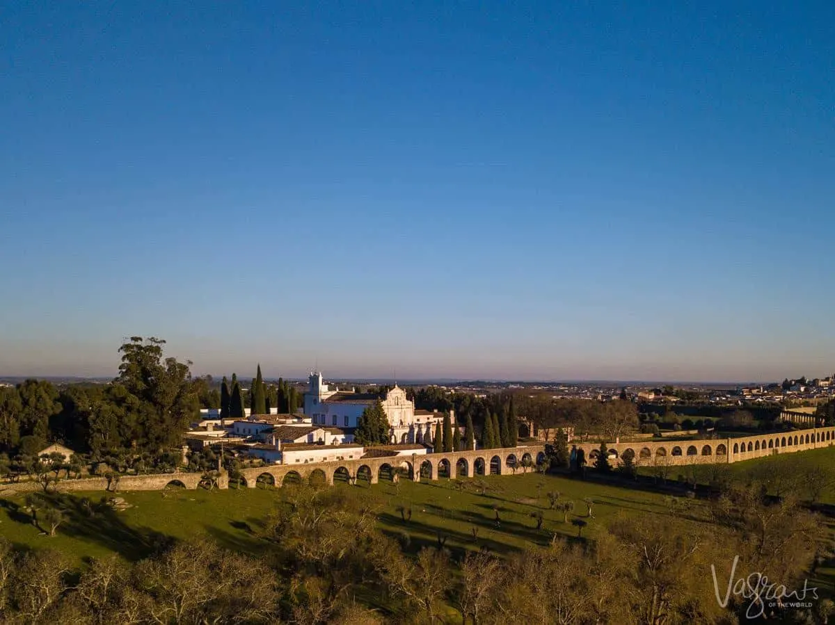 The aqueduct in Evora runs through the countryside and past an old monastery. 