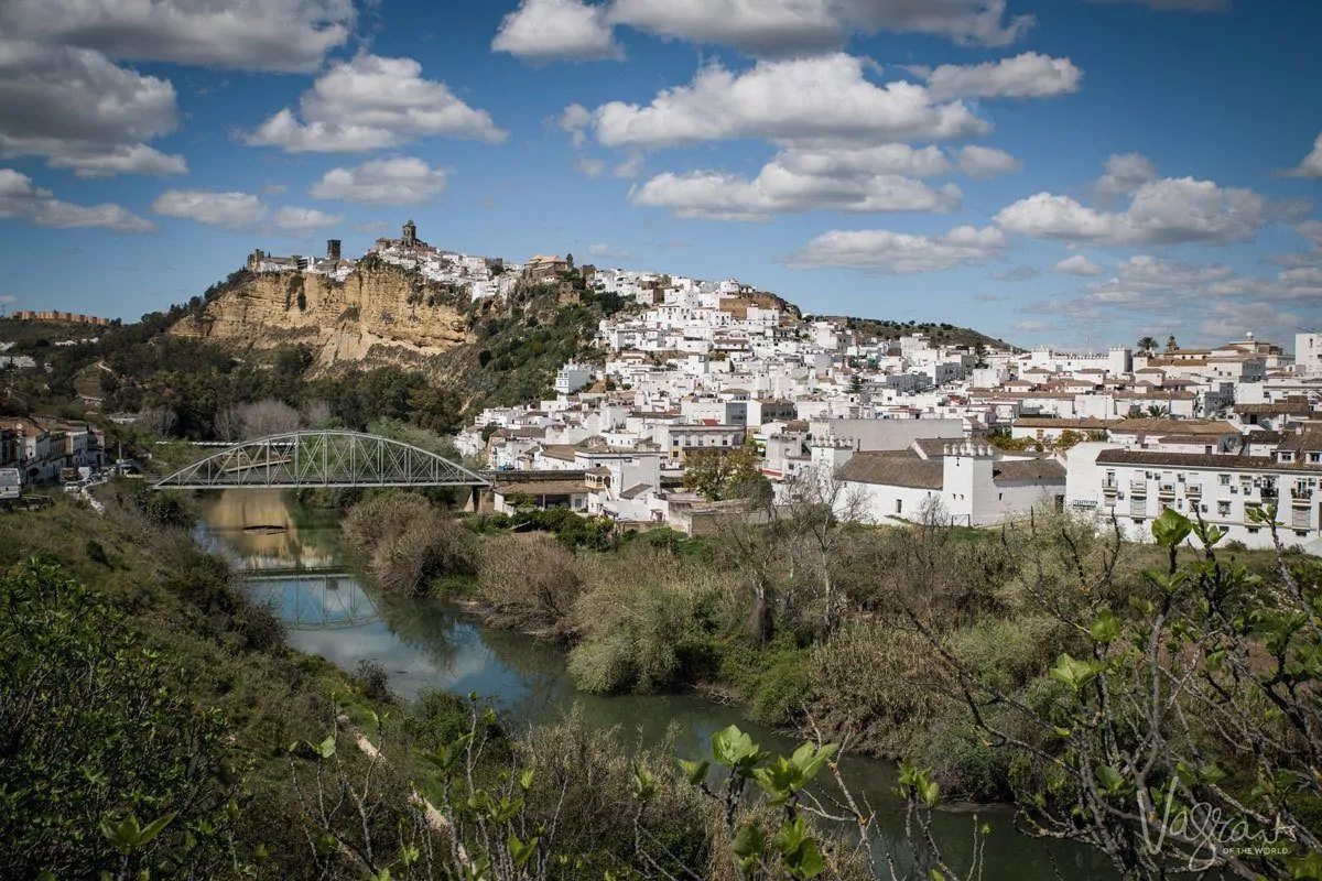 One of the most beautiful white villages of Spain, Arcos de la Frontera, white houses cascade down from the castle and cathedral along the riverfront.