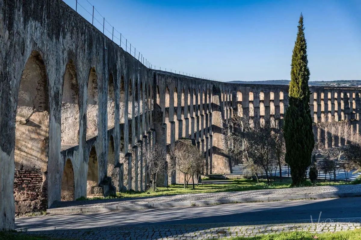 the very high aqueduct spanning across the city of elvas one of alentejo highlights and a must do on your alentejo portugal holiday