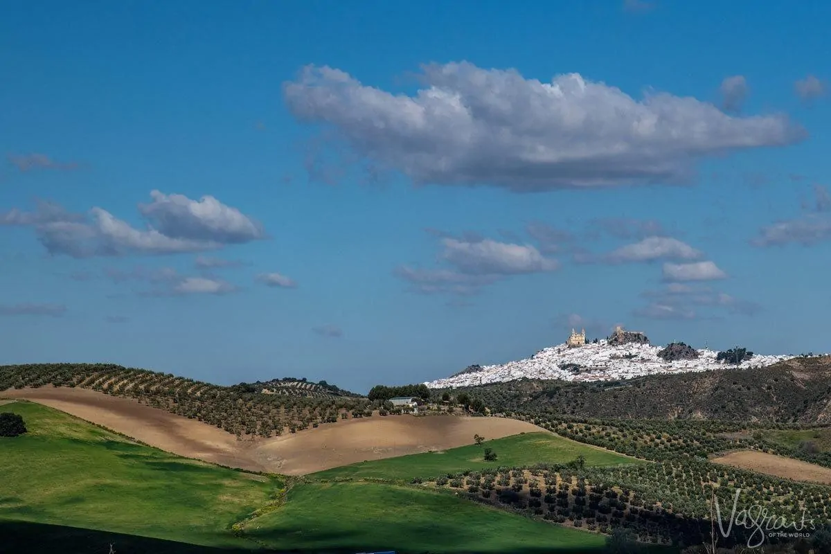 Green pastures to the cascading white village of Olvera, a must see on your southern spain white villages itinerary