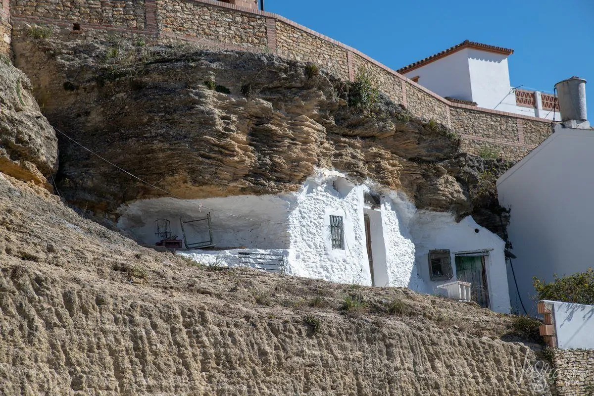 Small unique white house built into the rock cliff in Setenil de las Bodegas. 