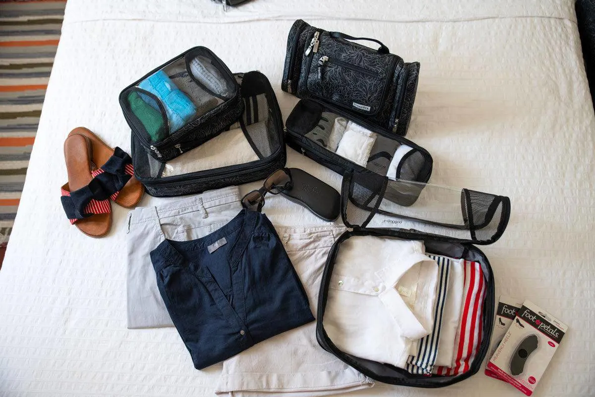 packing cubes laid out with an assortment of clothing.  