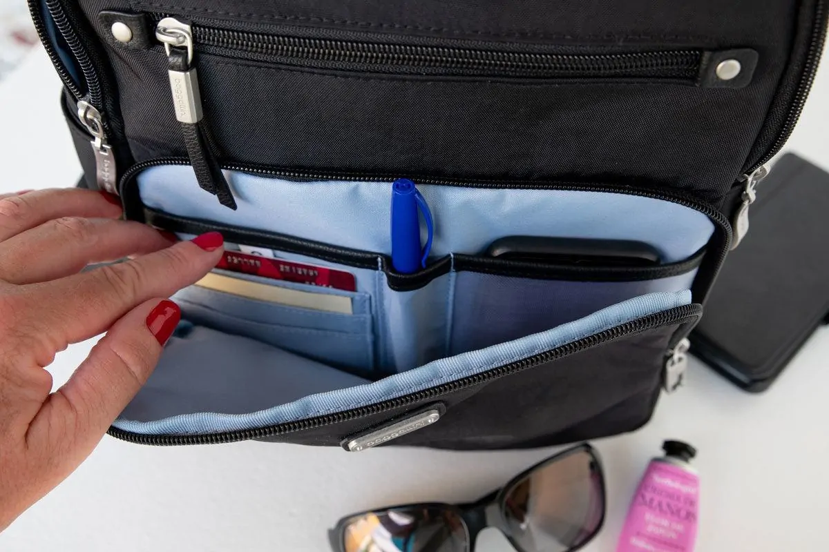 the rfid section of the antitheft area of a black backpack showing credit cards and a pen.  a good antitheft back pack for travel is essential