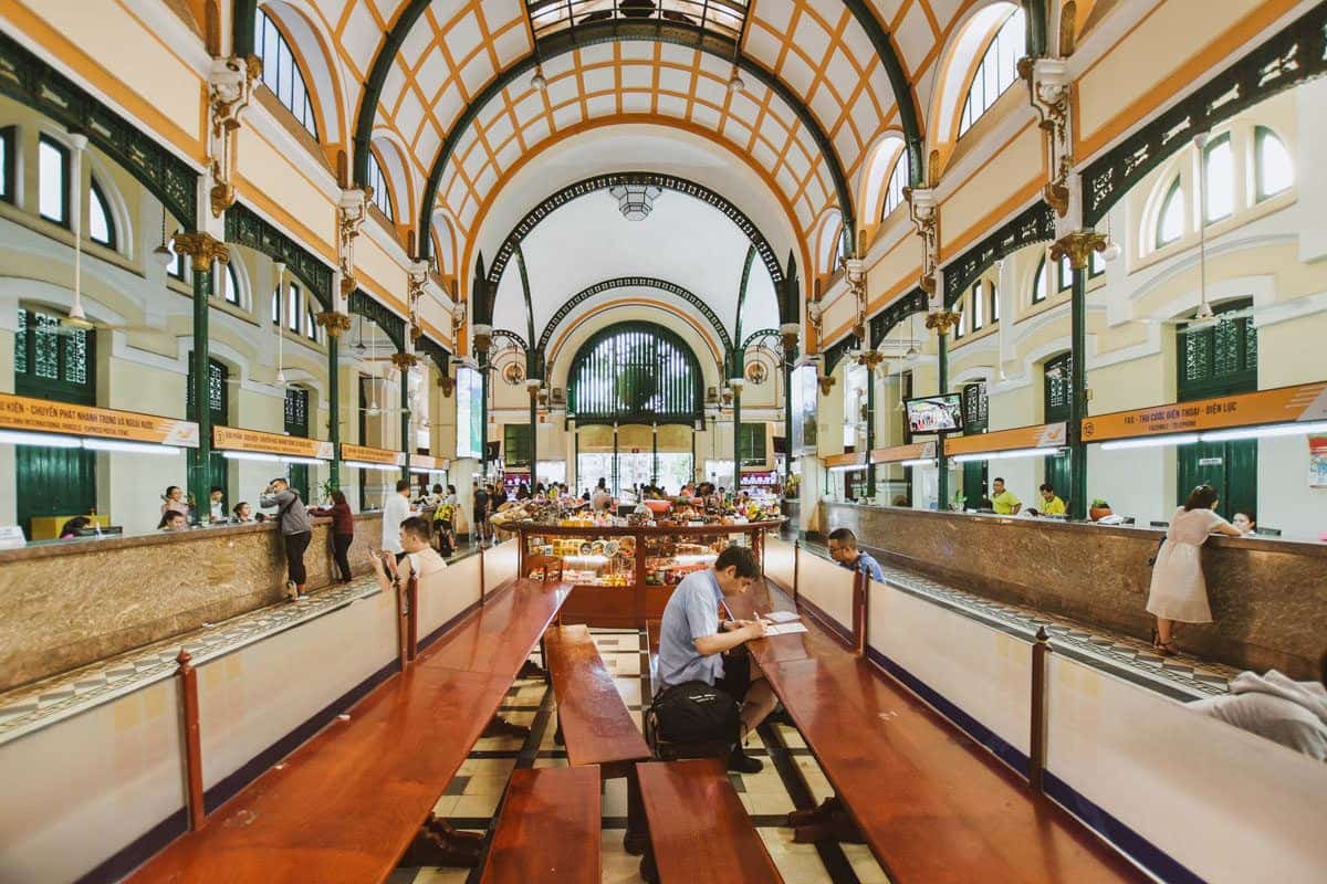 people inside the Saigon central post office with its domed roof. a visit here is a pleasant and unusal thing to do in ho chi minh city.