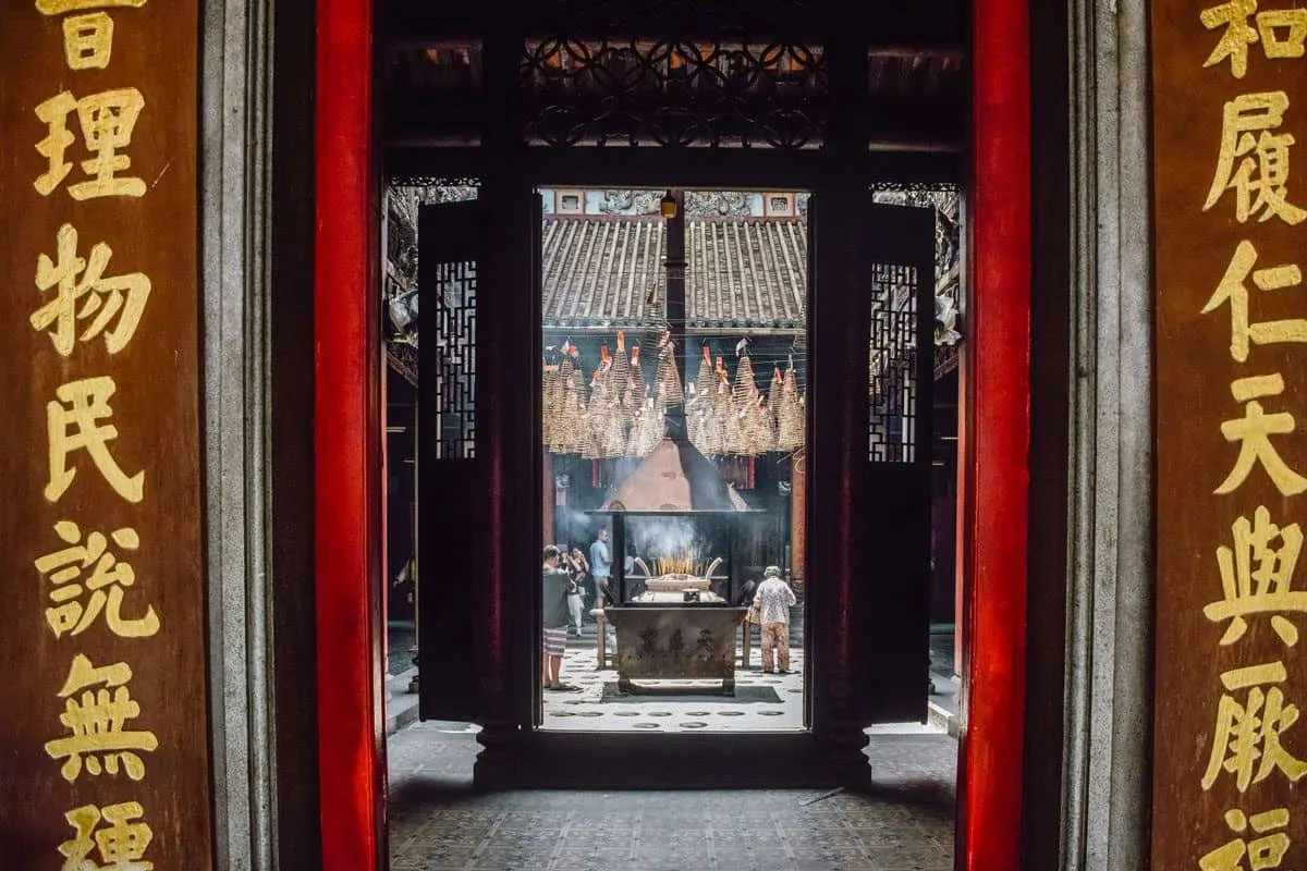 An incense fire as seen though the arched entrance. Add a stop here to your Ho chi minh city itinerary.